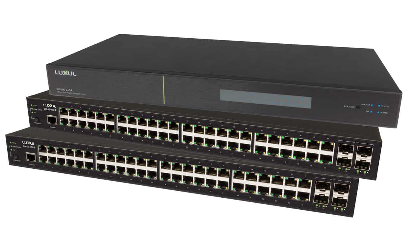 Stack Luxul gear: router atop two switches. Switches have Ethernet ports with lights; the router has a front digital display.