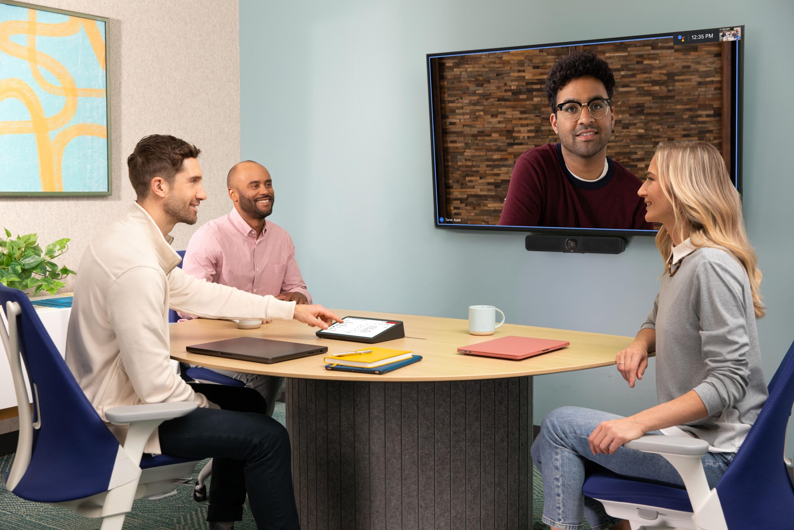 People in huddle room using Google Meet